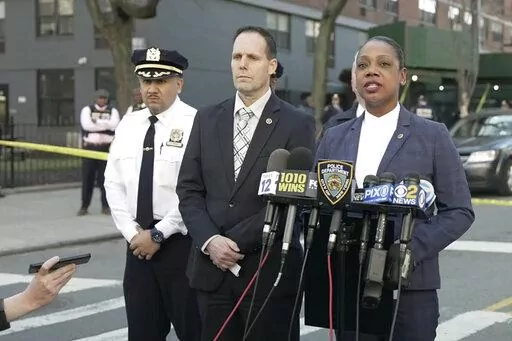 In this image taken from video provided by the NYPD, New York Police Commissioner Keechant Sewel, right, speaks during a news conference, Friday, April 8, 2022, in New York. A teenage girl has been killed and two other teens wounded in a shooting near a Bronx school. (NYPD via AP)